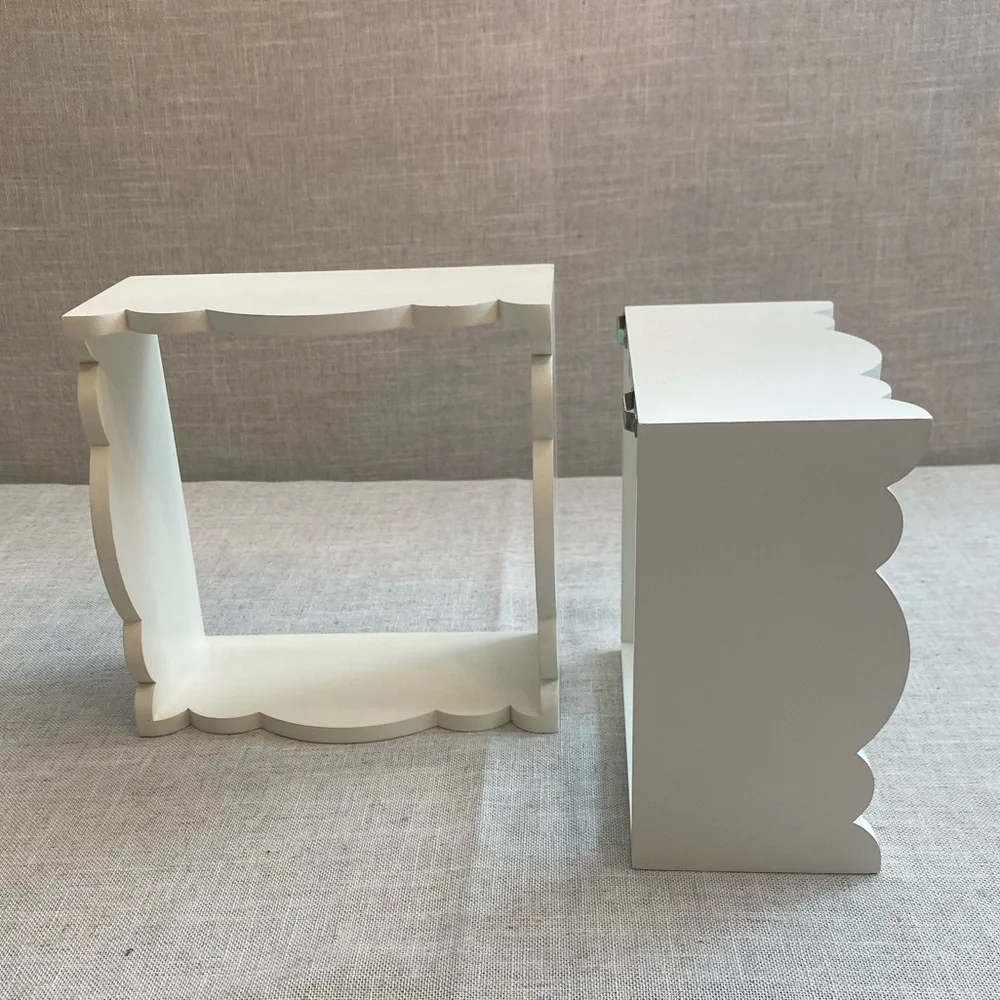 Two wall hanging white shadow boxes.